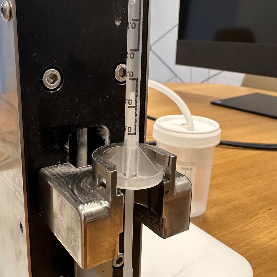 Dosing mechanism with syringe and sterile container